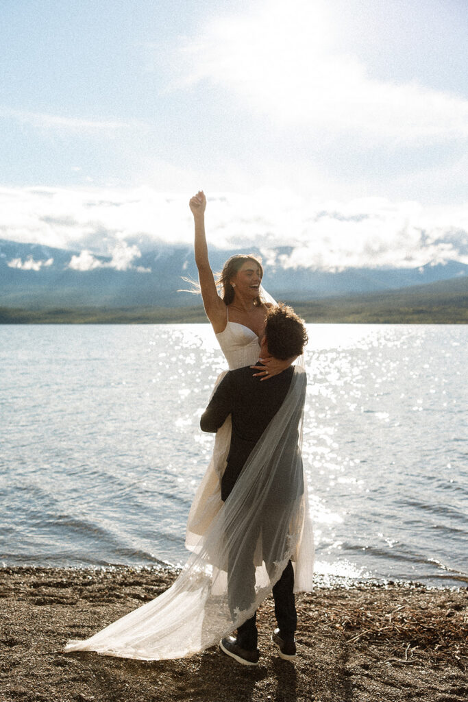 Scenic elopement portraits at 7 Mile Pullout overlooking Lake McDonald and the surrounding mountains.
