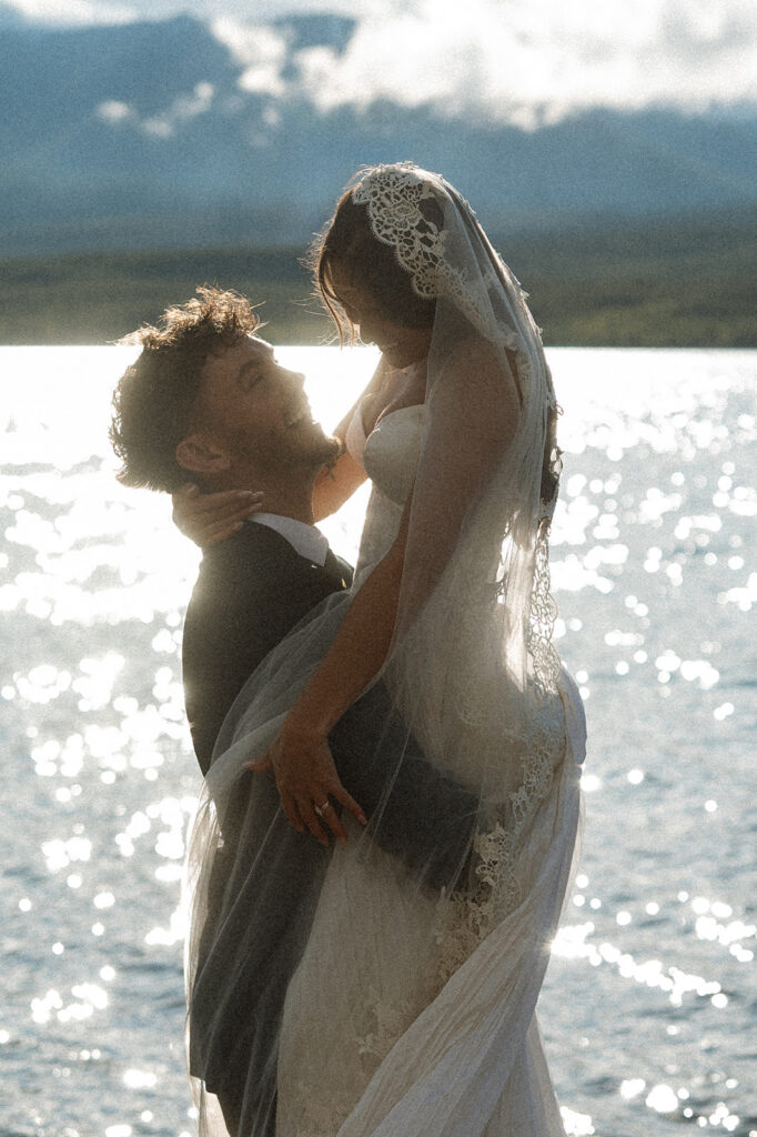 Scenic elopement portraits at 7 Mile Pullout overlooking Lake McDonald and the surrounding mountains.