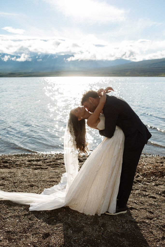 Scenic elopement portraits at 7 Mile Pullout overlooking Lake McDonald and the surrounding mountains.