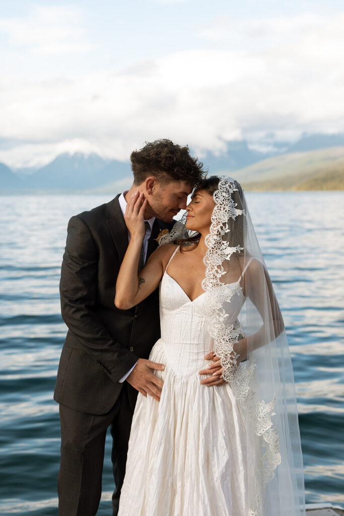 Newly married couple celebrating their Glacier National Park elopement in a beautiful natural landscape.