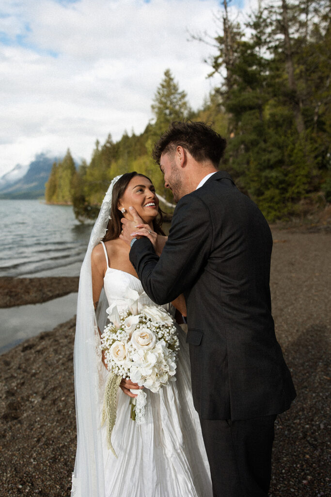 Scenic elopement portraits at 7 Mile Pullout overlooking Lake McDonald and the surrounding mountains.