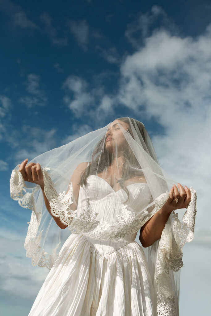 Scenic elopement portraits at 7 Mile Pullout overlooking Lake McDonald and the surrounding mountains.
