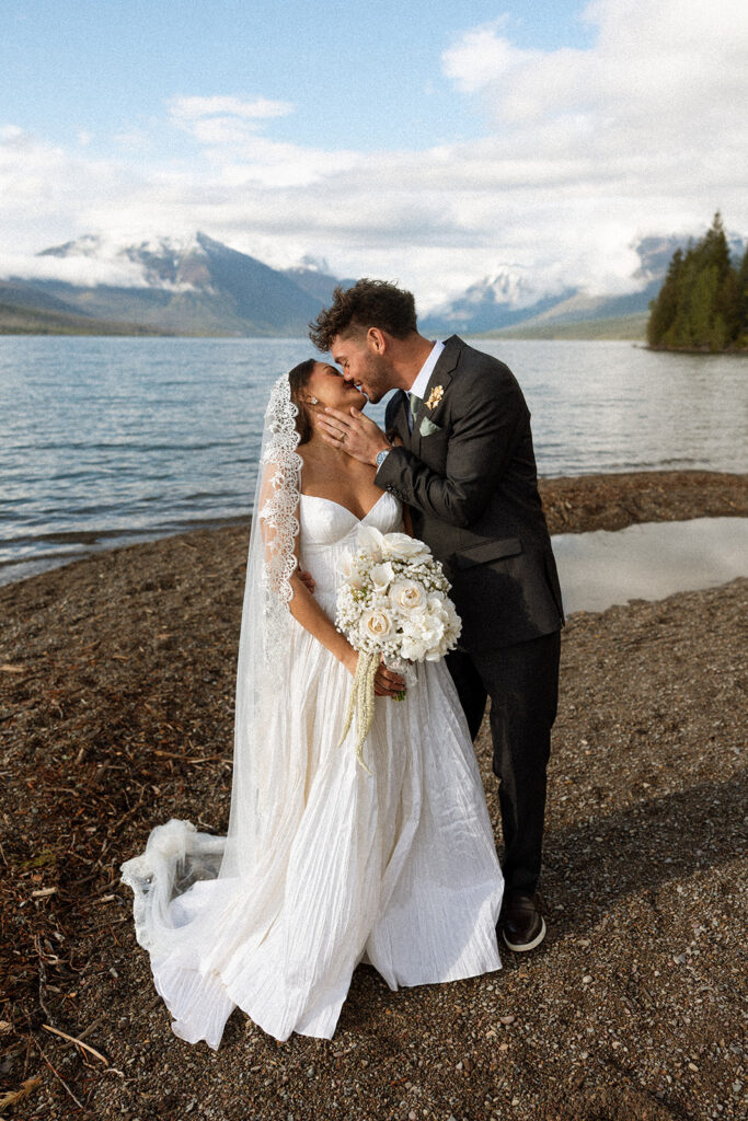 Scenic elopement portraits at 7 Mile Pullout overlooking Lake McDonald and the surrounding mountains.