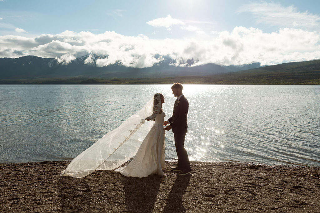 Scenic elopement portraits at 7 Mile Pullout overlooking Lake McDonald and the surrounding mountains.